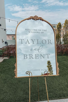 a welcome sign for the wedding of taylor and breint in front of an outdoor venue