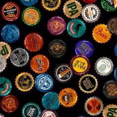 many different types of beer bottle caps are arranged in the shape of letters and numbers