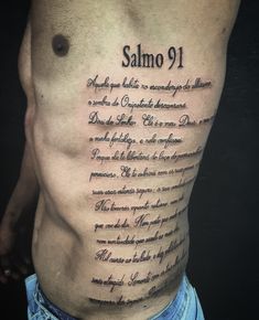 a man with a tattoo on his back saying salmo 9, and some words written in cursive writing