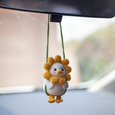 a stuffed animal hanging from the side of a car