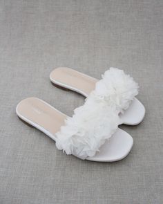 "Elegant slide flat sandals for casual and dressy look with added allover chiffon flowers. Simple and easy wear for brides, bridesmaids and/ or wedding parties. DETAILS: COLORS AVAILABLE: Ivory UPPER: Synthetic upper and lining MATERIALS: Mandmade outsole STYLE: EVELYN - Please see our \"Policies\" section for information regarding RETURNS and EXCHANGES. - Stay updated with latest news or promotion as we grow and follow us on the following outlets: Instagram: http://instagram.com/shop.kaileep Fa Cute Beach Shoes Bow Slides White, Cheap Sandals For Party, Cheap White Slip-on Footbed Sandals, Cheap White Fun Sandals, Cheap White Summer Slippers, Cheap Fun White Sandals, Luxury White Sandals For Spring, Cheap White Sandals For Playtime, Cheap Elegant White Sandals