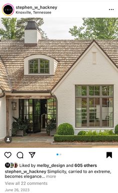 a white house with brown shingles on the roof and windows is featured in an instagram