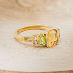 Product Details Ring Style: "Hazel" is an accented-style citrine women's engagement ring with peridot and diamond accents. Many other center stone options are available upon request. Center Stone: 8x6mm Emerald Cut Citrine Materials: 14K gold engagement ring featuring a citrine center stone, peridot accent stones, and 8 diamond accents Customizable: Because each ring is handcrafted to order, we can customize yours using unique materials, gemstones, or design features, often without any added cos Citrine Engagement Ring, Citrine Ring Engagement, Staghead Designs, Montana Sapphire, Detailed Ring, Unique Materials, Unisex Ring, Gold Engagement Ring, Ring Style