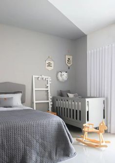 a baby's room with a crib, rocking horse and bed in it