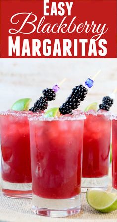 three glasses filled with blackberry margaritas and garnish