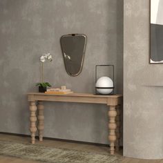 a wooden table sitting in front of a mirror on top of a wall next to a fireplace