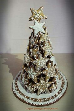 a christmas tree made out of cookies on top of a white and gold plated platter