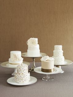 three tiered cake stands with different types of cakes on each platter, one is white and the other is gold