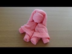 a pink teddy bear wrapped in a towel