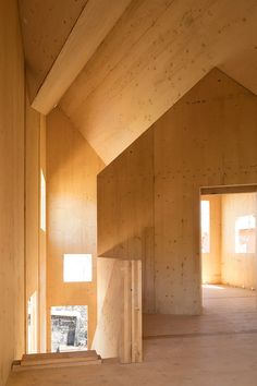 an empty room with wooden walls and stairs