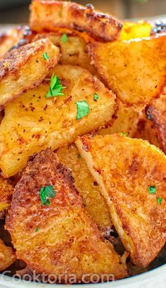 fried potatoes with parsley in a white bowl