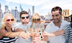 group of friends toasting with champagne in front of city skyline