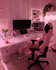 a pink office chair sitting in front of a white desk with a computer on it