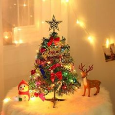 a small christmas tree with lights and decorations