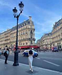 a woman is walking down the street in paris