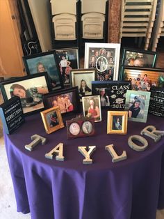 a purple table topped with pictures and framed photos