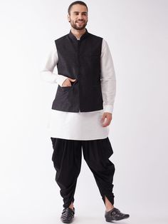 Vastramay Men Cream & Black Layered Kurta with Cowl Dhoti & Jacket Traditional Black Cotton Nehru Jacket, Traditional Black Nehru Jacket For Winter, Traditional Black Outerwear For Eid, Traditional Black Bandhgala For Winter, Traditional Black Sets For Fall, Traditional Cotton Sherwani For Winter, Traditional Black Cotton Bandhgala, Fitted Black Traditional Wear For Winter, Traditional Black Kurta For Fall