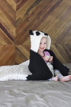 This free crochet hooded baby afghan pattern will give your favorite child the chance to feel like a cozy little panda. Make one for the new baby to grow into and another for an older sibling to enjoy right away! Customize the pattern to make a crochet koala or polar bear too! Made with Lion Brand Wool Ease Thick & Quick in "Fisherman" and "Black." Click for the free crochet pattern! Crochet Blanket Black, Unique Crochet Blanket, Crochet Hat Ideas, Crochet Ripple Pattern, Baby Afghan Patterns, Make And Do Crew, Crochet Hood, Bear Blanket, Lion Brand Wool Ease