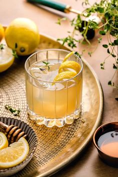 a glass filled with lemonade sitting on top of a table