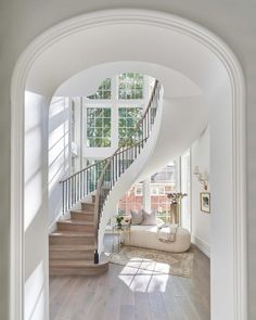 an arched staircase leads to the second floor