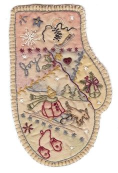 an embroidered christmas stocking hanging on a wall