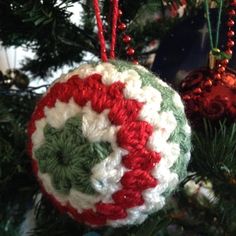 a crocheted ornament hanging from a christmas tree