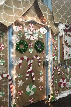 the front door decorated for christmas with candy canes, wreaths and decorations on it