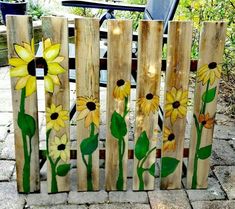 a wooden fence with painted flowers on it