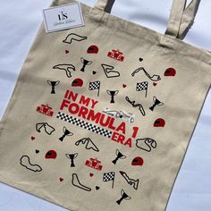 a tote bag with designs on it and the words in my formula 1 era