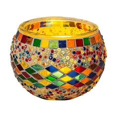 a glass bowl that has been decorated with multicolored tiles on the outside and inside