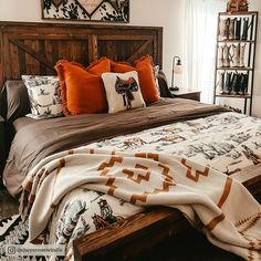 a bedroom with a large bed covered in blankets and throw pillows on top of it