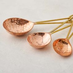 three copper spoons sitting on top of each other