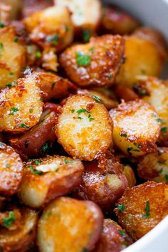 potatoes in a white bowl with parsley on top and the words, 15 foods you can eat and not gain weight