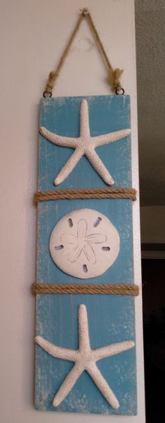 a blue and white wall hanging with two starfishs