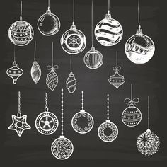 christmas ornaments hanging from strings on a chalkboard background