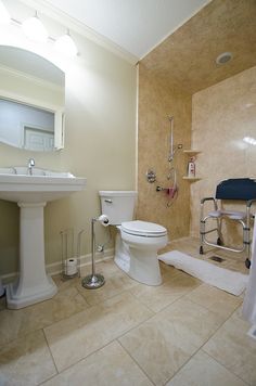 a white toilet sitting in a bathroom next to a sink