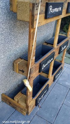 a wooden shelf with bins on the side of it