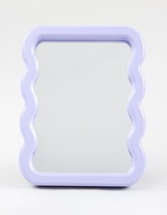 a white and blue mirror on a white surface with an empty space in the middle