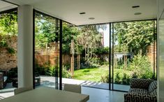 an open living room with sliding glass doors leading to the back yard and garden area