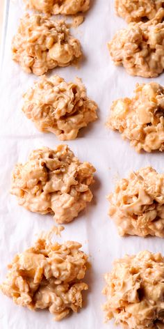 several cookies are arranged on a sheet of wax paper and ready to go into the oven