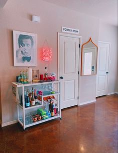 there is a shelf with bottles on it in the room next to two doors and a mirror