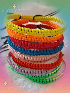 multicolored bracelets are stacked on top of each other