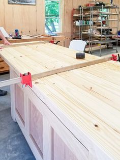 a man is working on some wood in his workshop