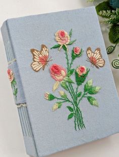 a blue book with flowers and butterflies on it