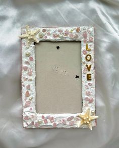 a white frame with shells and starfish on it