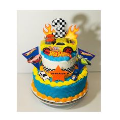 a birthday cake decorated with cars and race flags