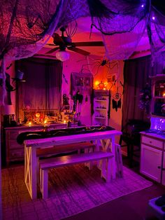 a kitchen with purple lighting and decorations on the ceiling