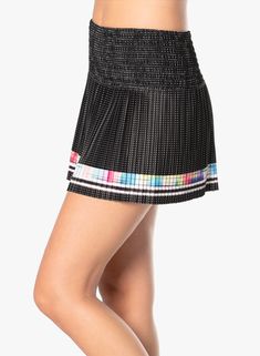 Court couture that bring contemporary styling to tennis in this performance smocked skirt. Done in an ultra lightweight performance fabric it also features a mesh polka dot print, bold ombre racing stripe border and a contrast parrot blue shortie for a pop of color as you move across the court. Black Pleated Tennis Skirt For Summer, Black Athleisure Skirt For Summer, Sports Black Pleated Skort, Black Pleated Tennis Skirt For Sports, Black Athleisure Skort With Lined Skirt, Spring Black Athleisure Skirt, Sporty Black Pleated Skort, Black Athleisure Skirt For Spring, Athleisure Black Lined Skort