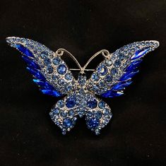 "Pieces are attached using a special jewelry adhesive. Please read descriptions thoroughly for sizes and materials.  This is a gorgeous silver metal brooch featuring a large metal butterfly ornament, with dazzling blue faceted jewels that sparkle  in the light. It's a really fun way to dress up any outfit, or as the something blue on your wedding day! 2\" long, and 2 1/2\" wide. Make sure to check out my shop for more hair pins, jewelry, accessories, and all sorts of fun stuff! Blue Butterfly, J Silver Butterfly Pins For Gift, Silver Butterfly Brooch For Wedding, Bat Jewelry, Insect Brooch, Butterfly Insect, Silver Hair Comb, Butterfly Ornaments, Metal Brooch, Butterfly Butterfly