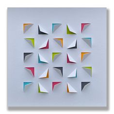 several different colored origami pieces arranged in a square